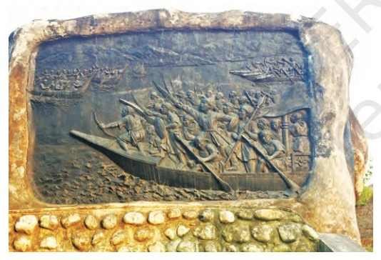 A plaque commemorating the Battle of Saraighat with an Ahom boat in the foreground - Resistance to the Mughals - E-book NCERT